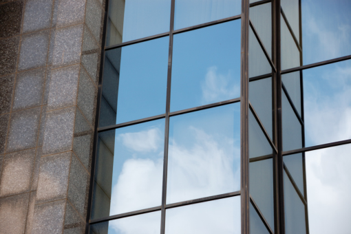 Multiple high-rise office buildings with windows requiring regular high-rise cleaning services.