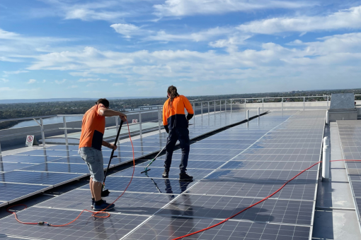 A modern building with a wavy, geometric facade featuring reflective glass windows and metallic cladding, highlighting the need for high-rise cleaning services.
