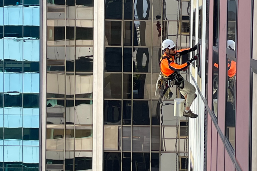 Multiple high-rise office buildings with windows requiring regular high-rise cleaning services.
