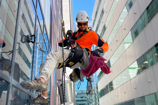 A rope access cleaner from the Blue Yonder Access team carrying out a clean of a strata. complex in Perth, WA.