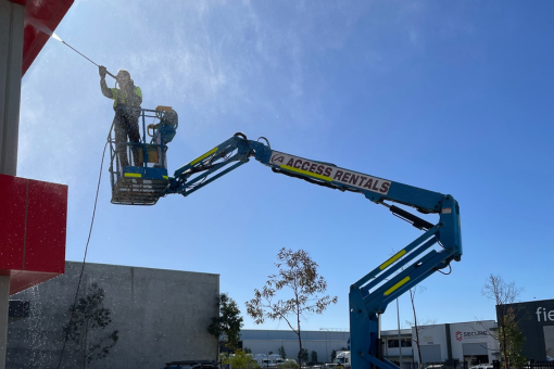Modern school courtyard with a playground and students walking with a teacher in front of contemporary educational buildings.