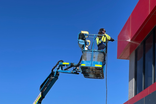 A rope access cleaner from the Blue Yonder Access team carrying out a clean of a strata. complex in Perth, WA.