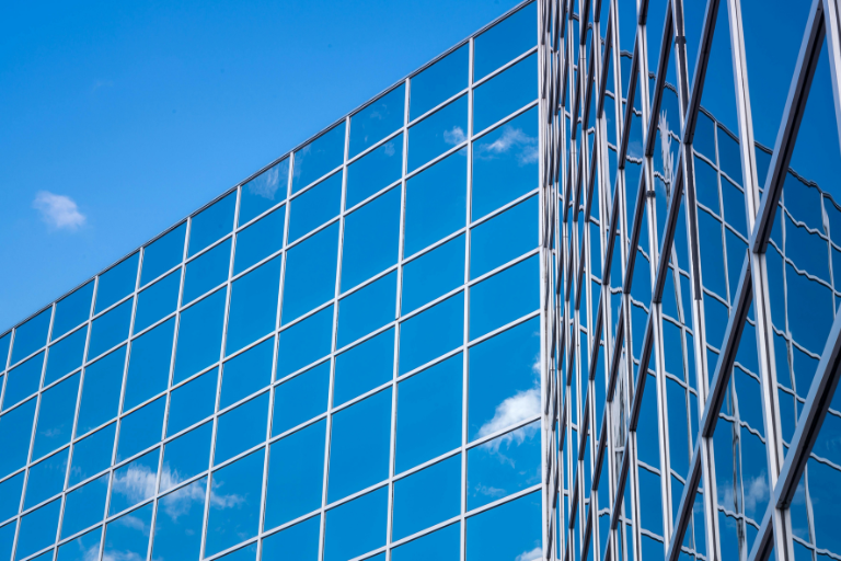 Multiple high-rise office buildings with windows requiring regular high-rise cleaning services.